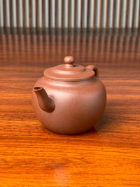 right view of handmade yixing teapot named ping gai lian zi on the table