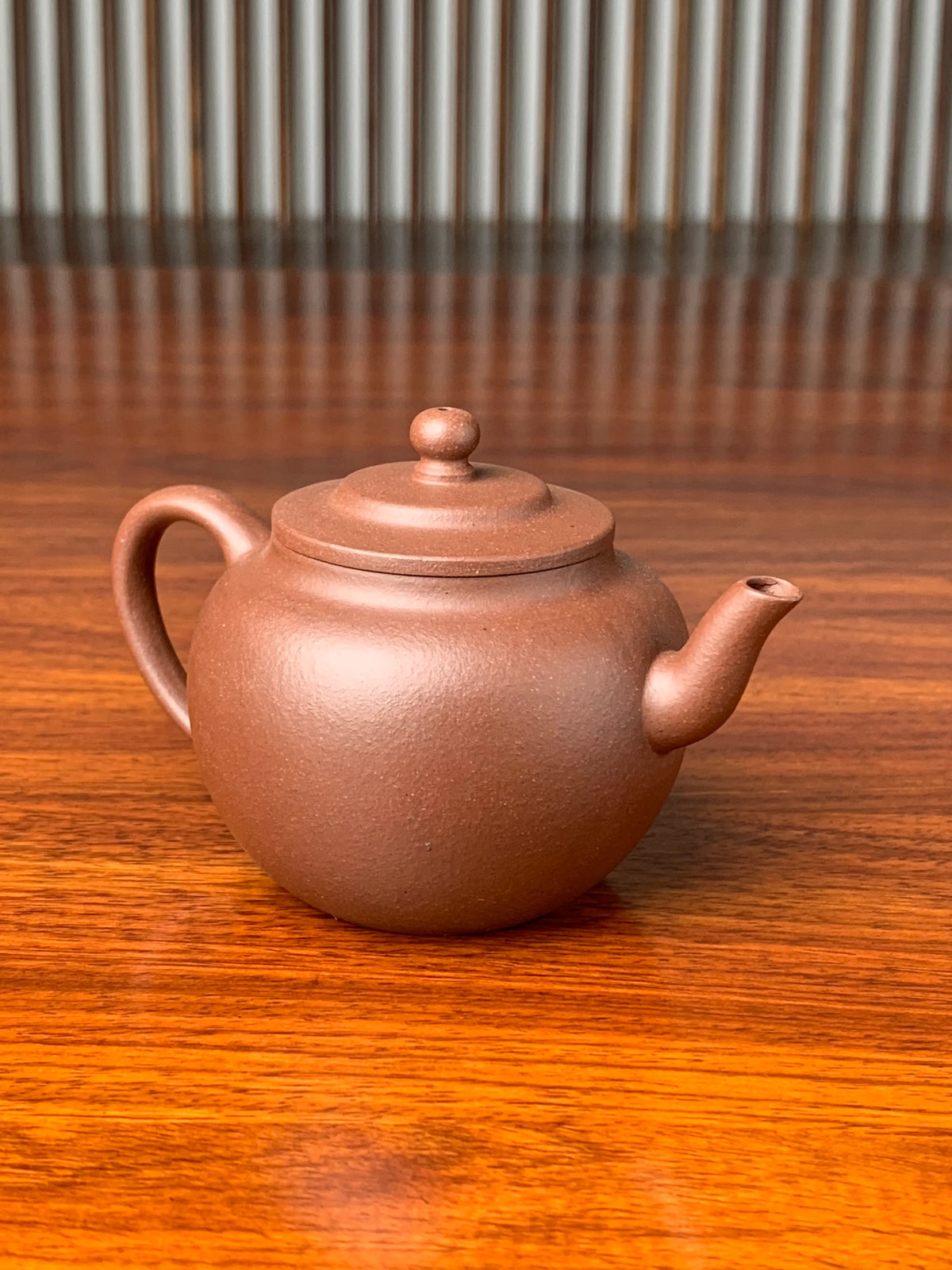 left view of handmade yixing teapot named ping gai lian zi on the table