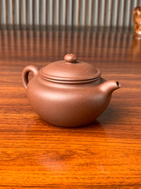 the left view of the handmade yixing teapot named yong fu lian zi