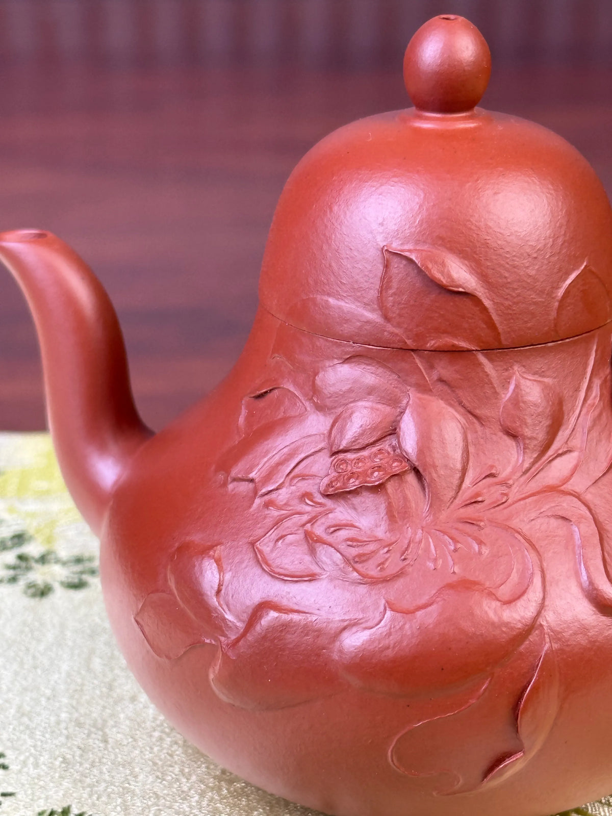 The details of the clay-painted lotus motif on the handmade yixing teapot