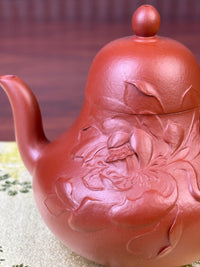 The details of the clay-painted lotus motif on the handmade yixing teapot
