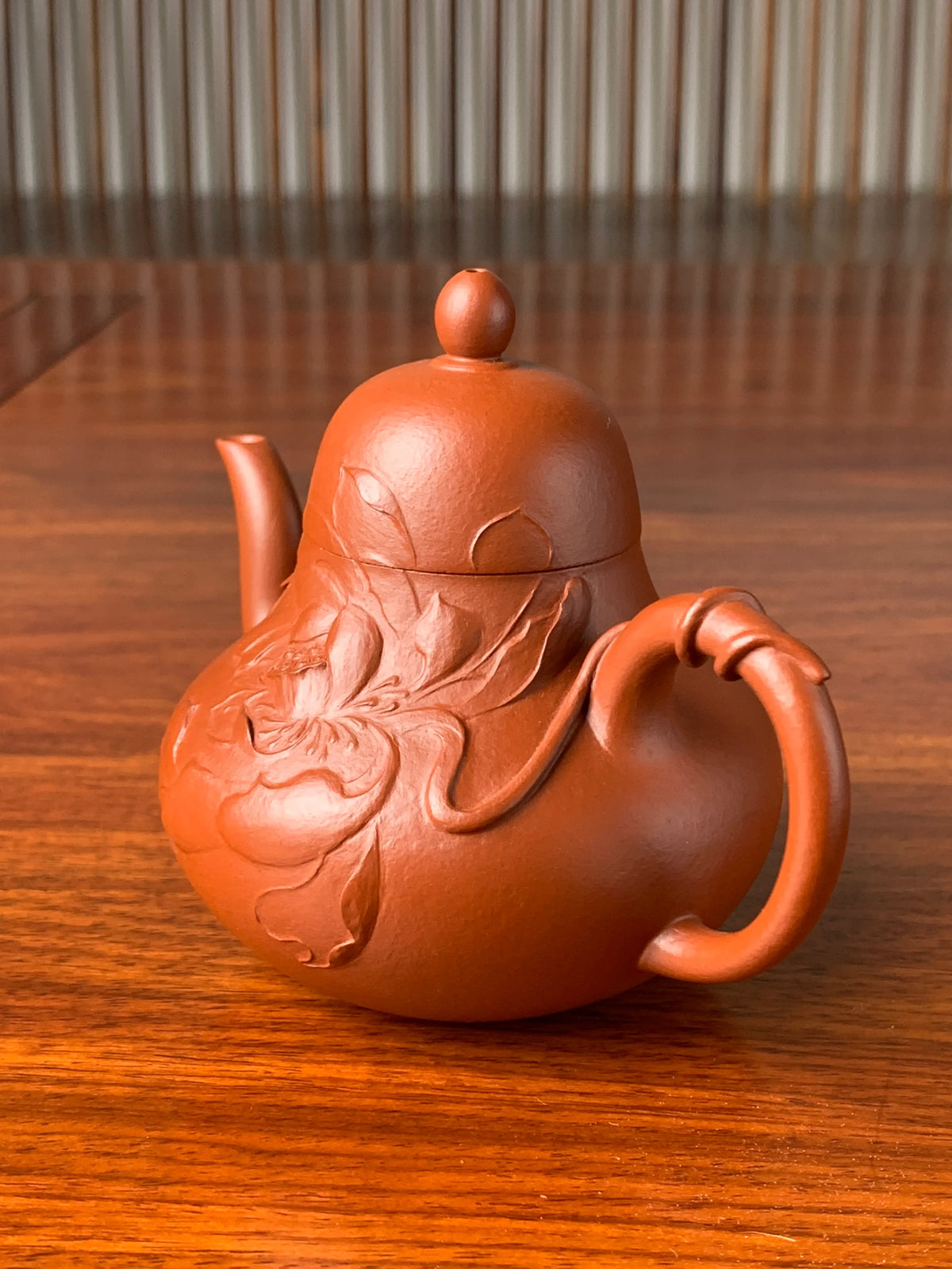 Right-side view showing the details of the lotus clay-painted motif on the teapot