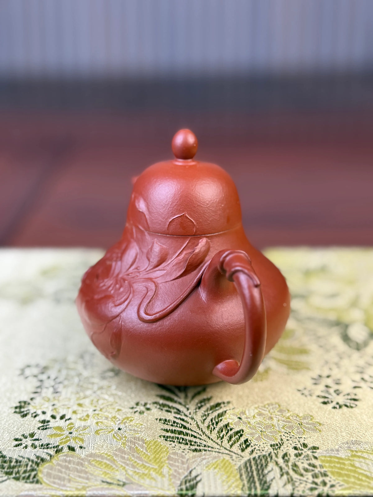 Right-side view showing the details of the lotus clay-painted motif on the teapot