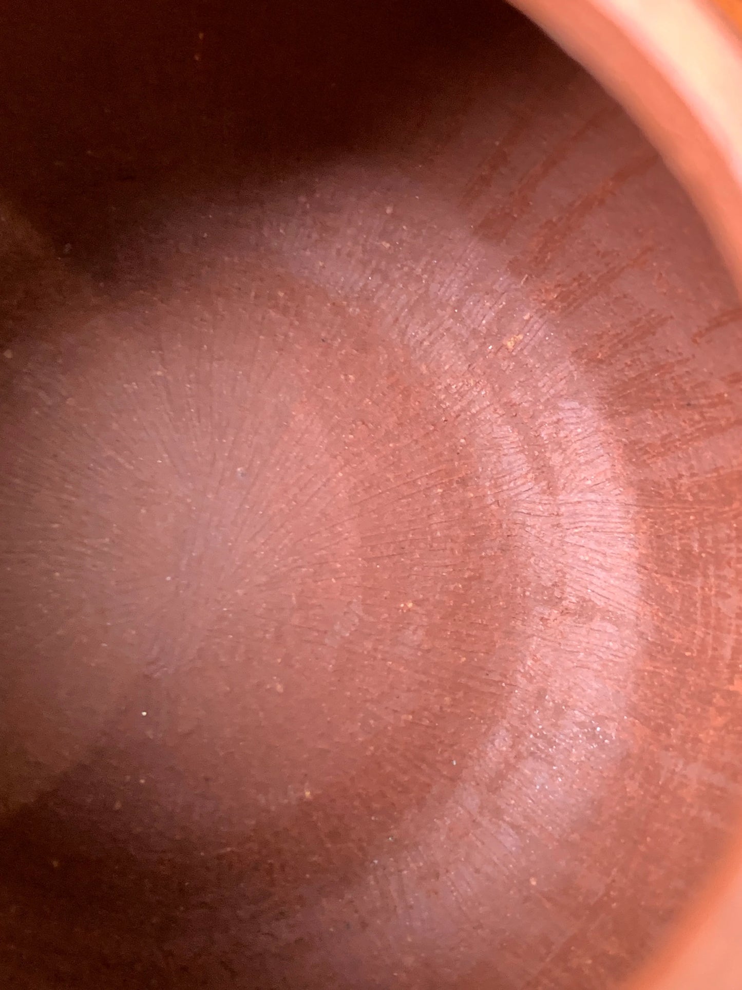 The interior tool marks and traces from the teapot's handmade process
