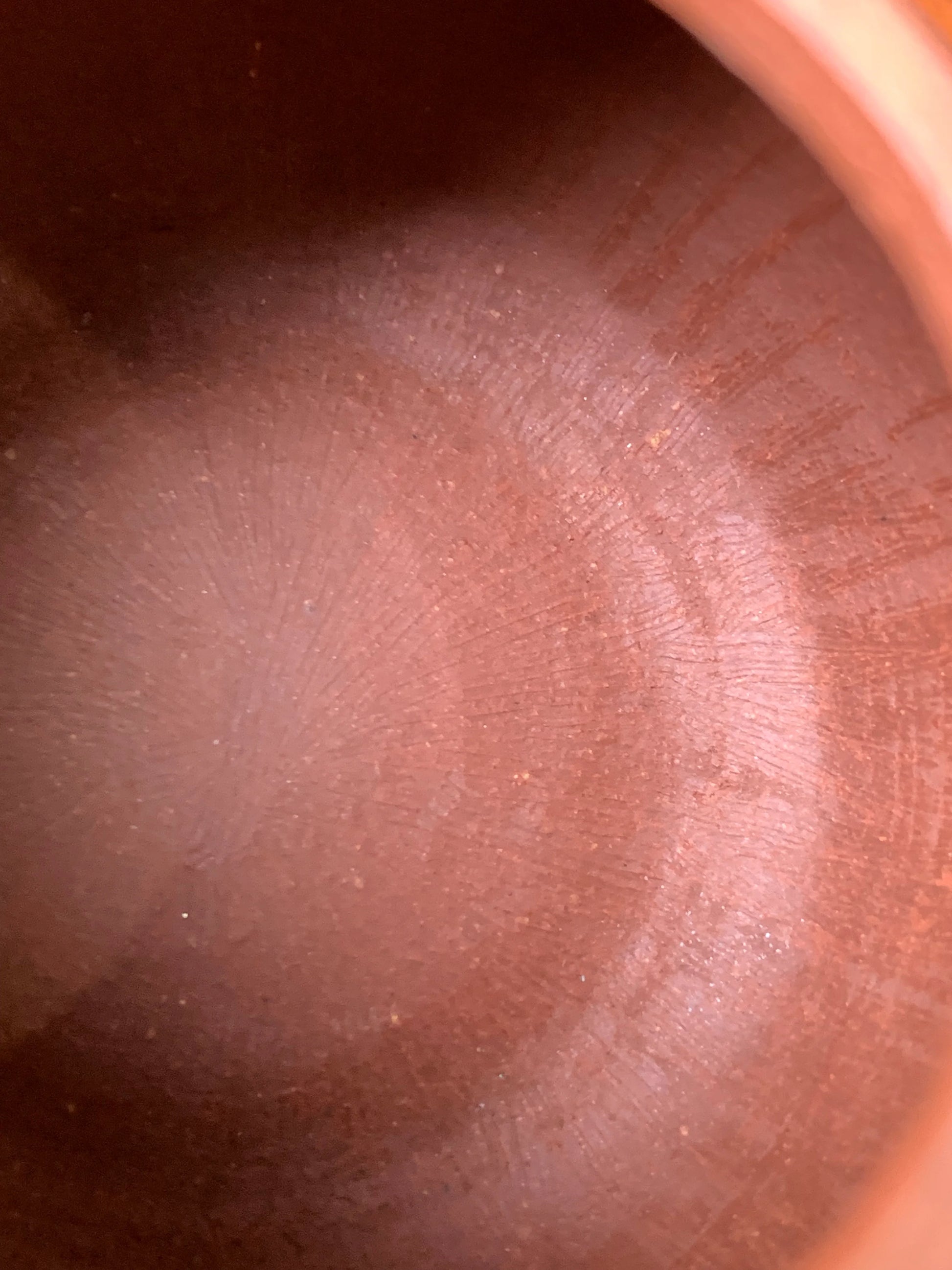 The interior tool marks and traces from the teapot's handmade process