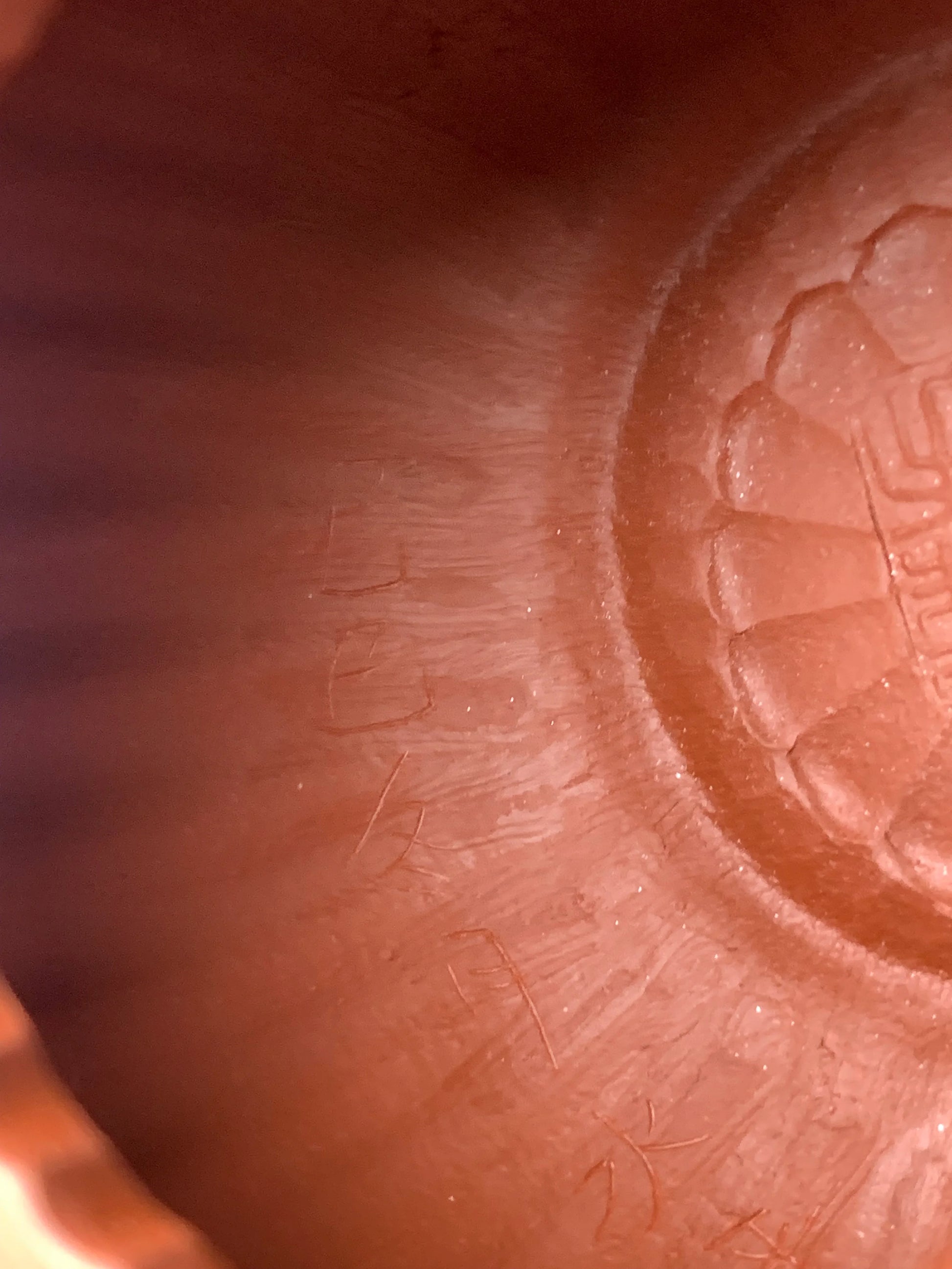 Tool marks left by handcrafting on the interior of the teapot