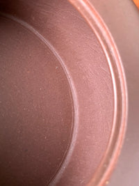 The loose clay texture (ni men) inside the teapot, characteristic of fully handmade craftsmanship