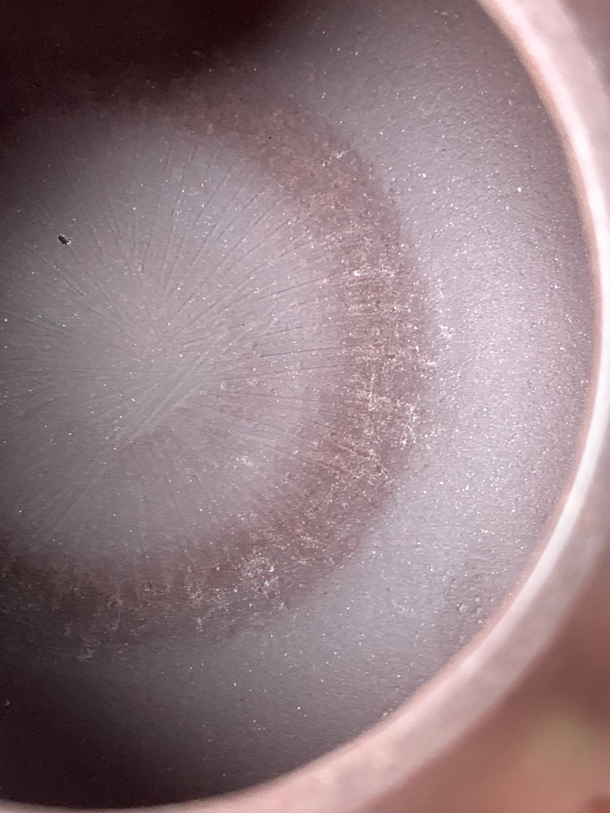 The bottom on the inside of the teapot bears traces of handcrafting