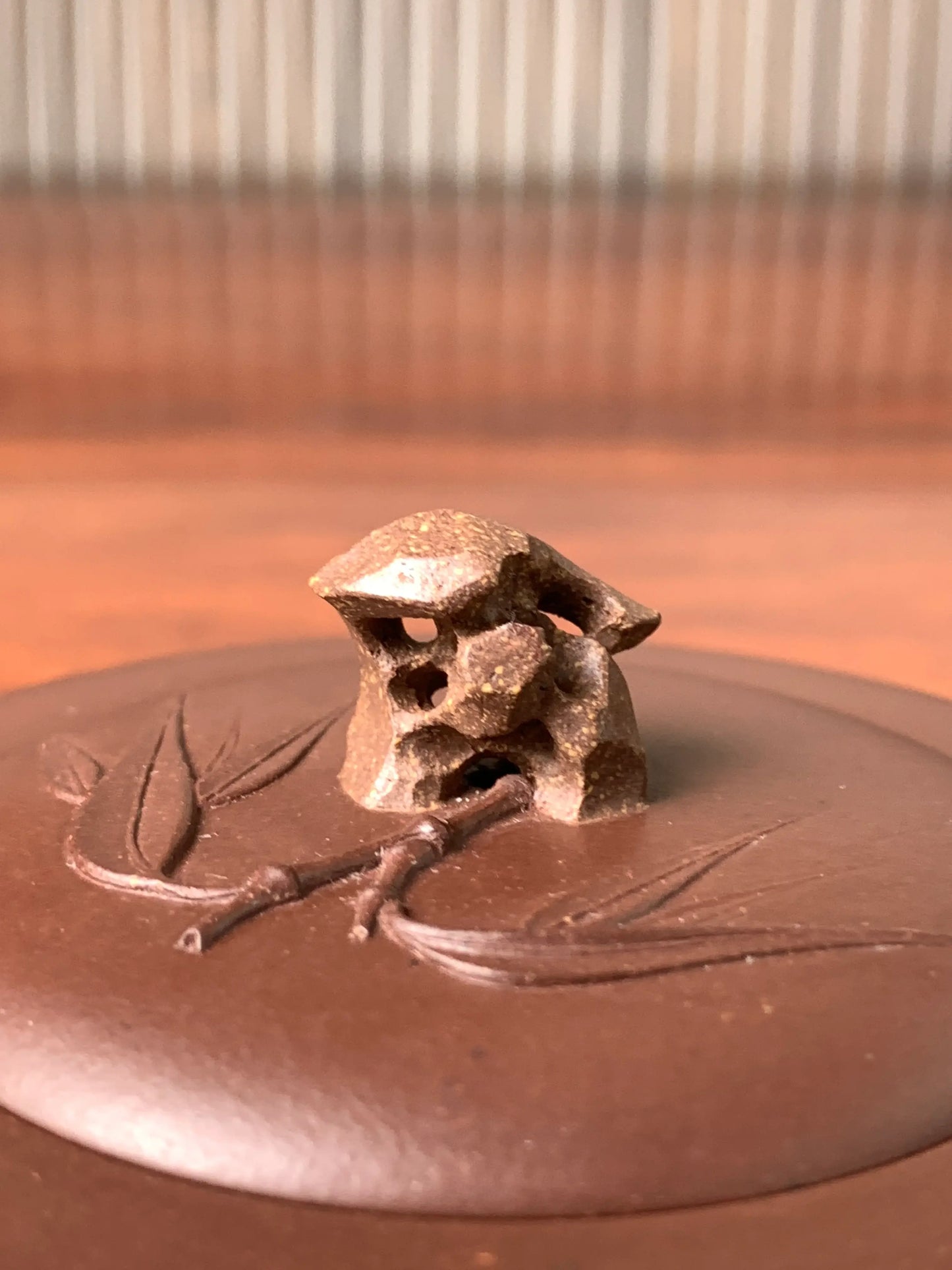 Close-up details of the rabbit-shaped pierced teapot lid knob