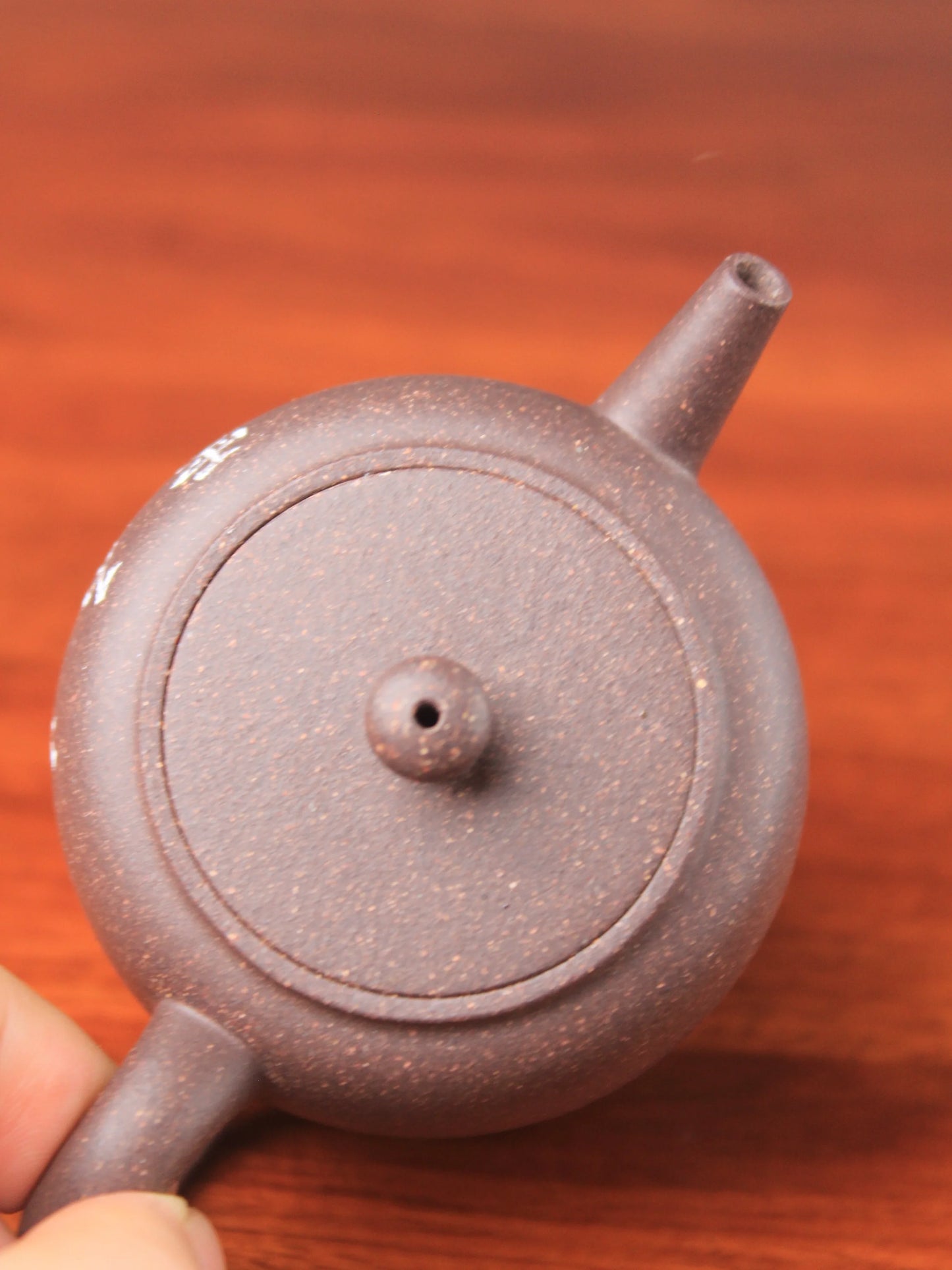 the konb of the handmade yixing teapot named ping gai
