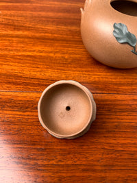 the lid of the artistic teapot on the table