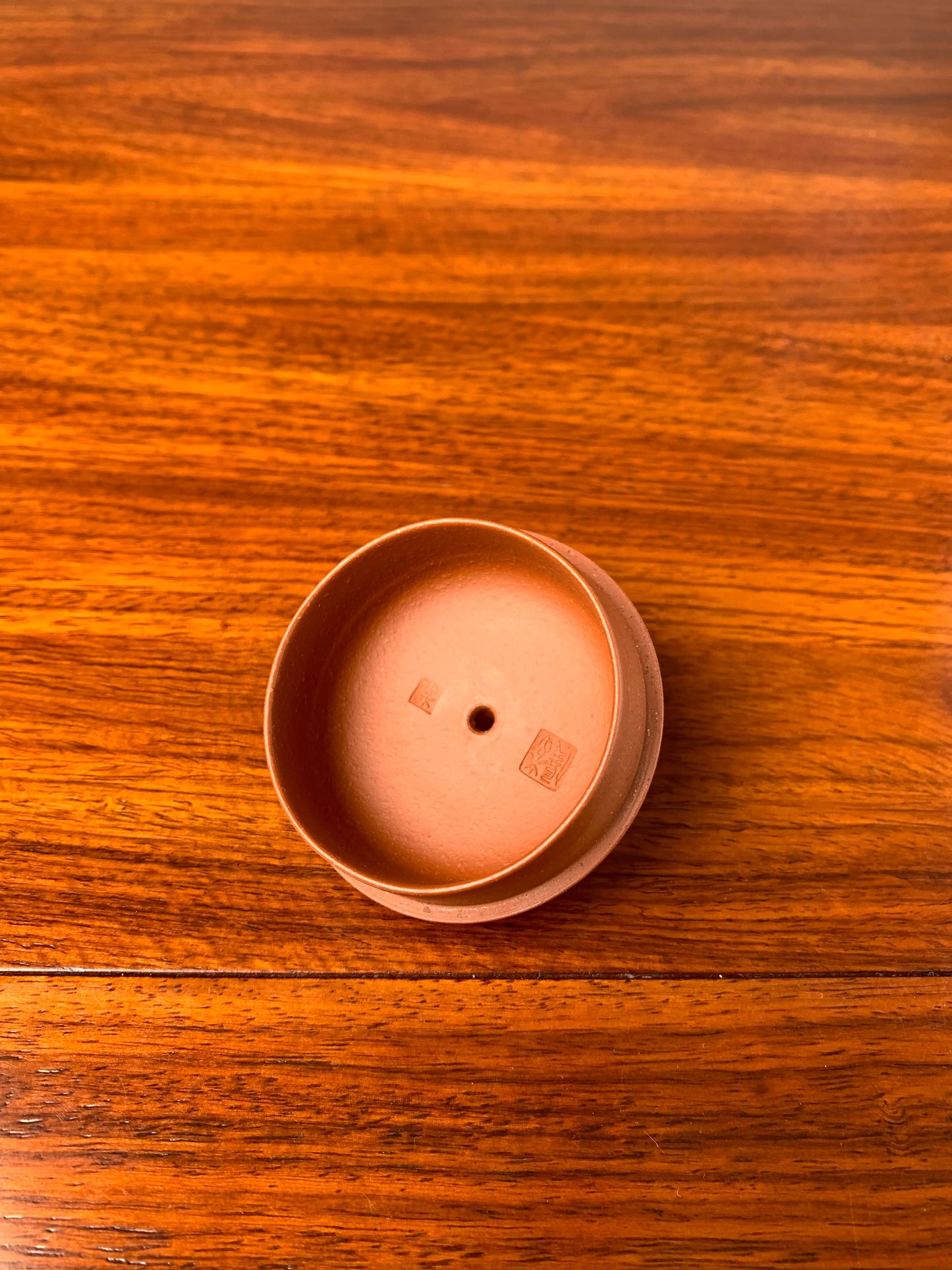 Lid of the handmade teapot on table