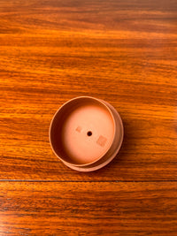 Lid of the handmade teapot on table