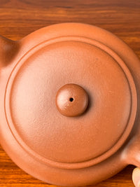 Looking down at the knob and lid of the teapot