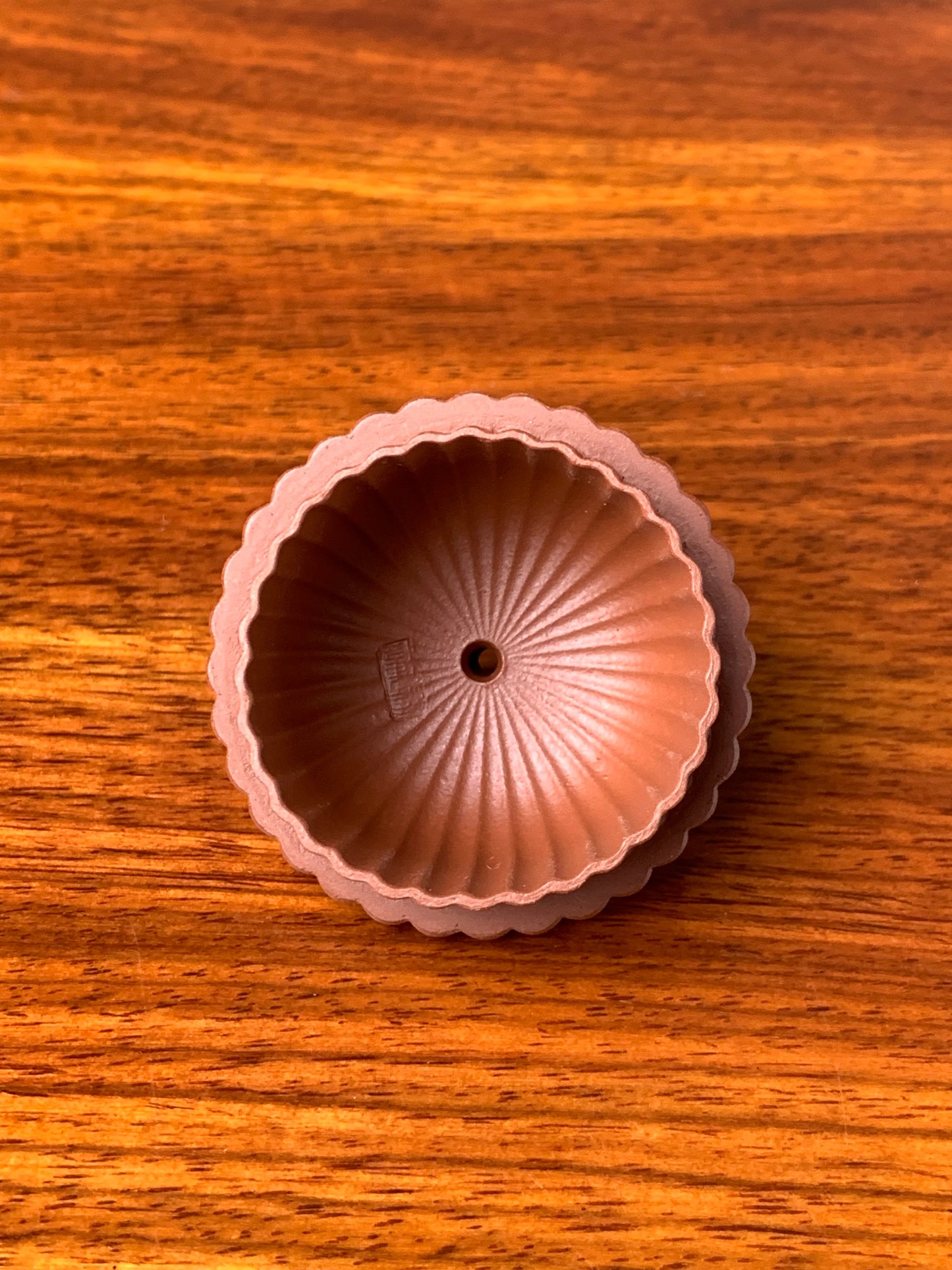 A photo of the inside of the yixing teapot lid