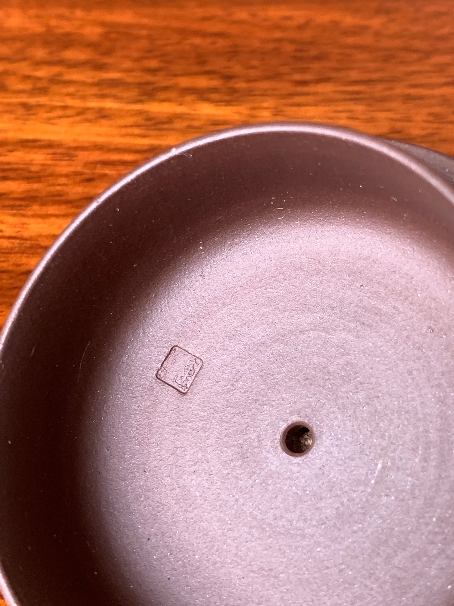 The underside of the teapot lid bears the impressed seal of artist Qian Xiaojun