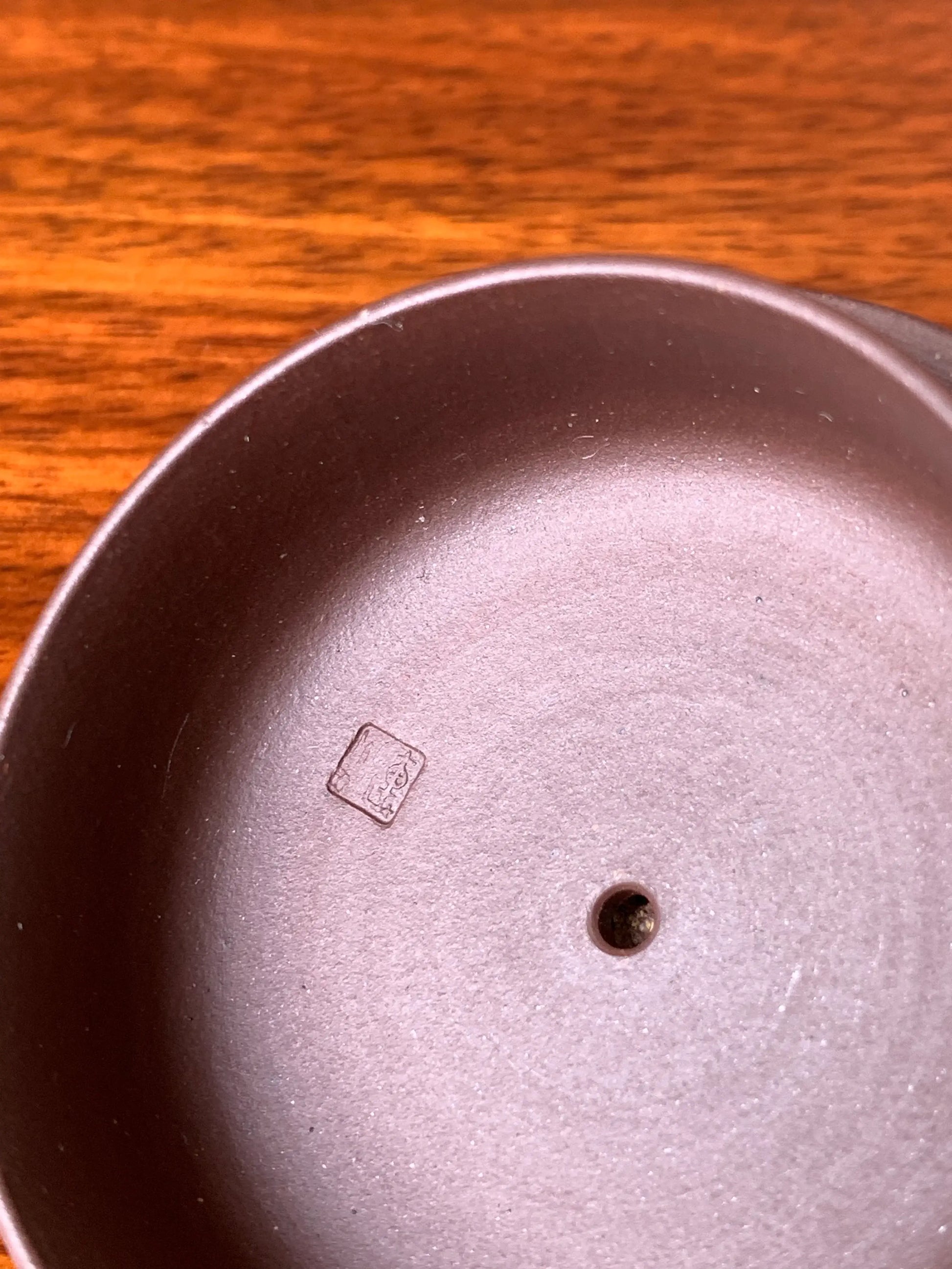 The underside of the teapot lid bears the impressed seal of artist Qian Xiaojun