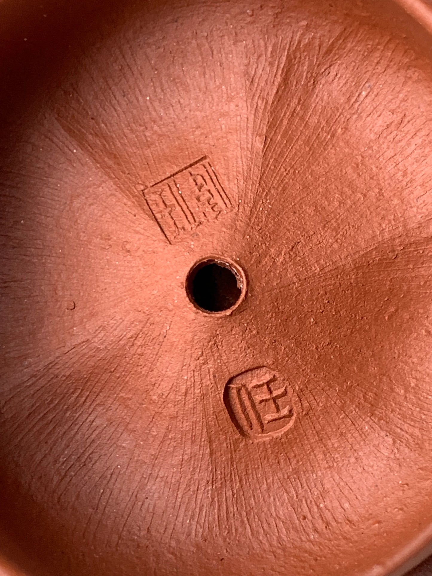 The inside of the teapot lid has the artist Wei Ren's mark