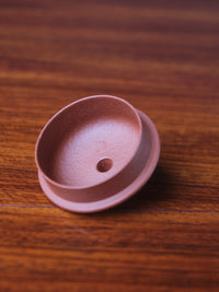 A  look at the lid of this handmade teapot on the table