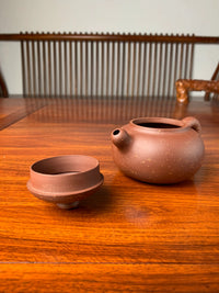 the teapot lid placed upside down and the teapot spout