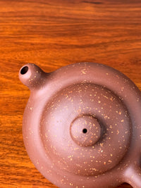 Top-down view of the details of the teapot lid and spout