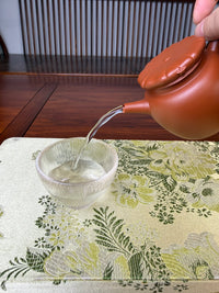 perfect pour of handmade yixing teapot jun hat