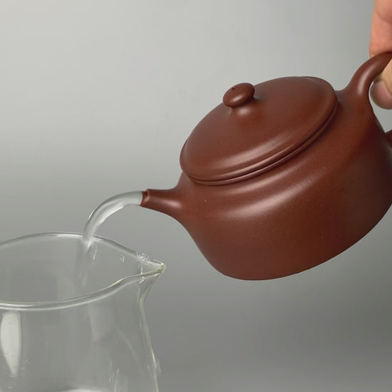 the pour of the chinese teapot yixing named de zhong is good