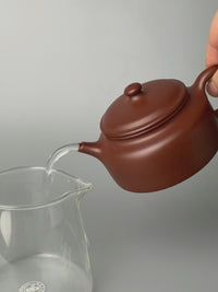the pour of the chinese teapot yixing named de zhong is good