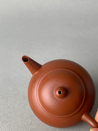 Looking down at the details of the teapot's lid and spout