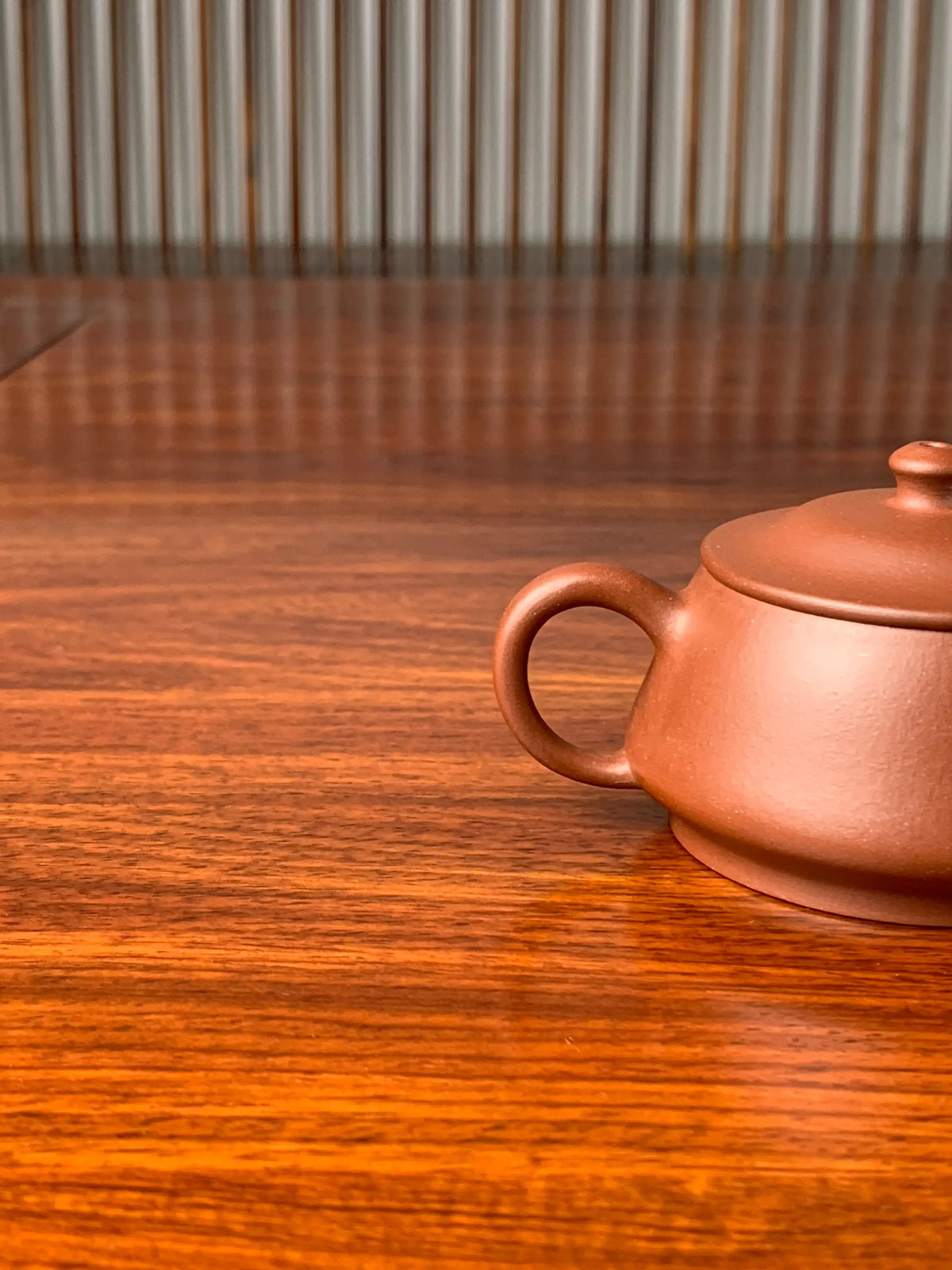 A close-up look at a small Yixing teapot named zhu chu