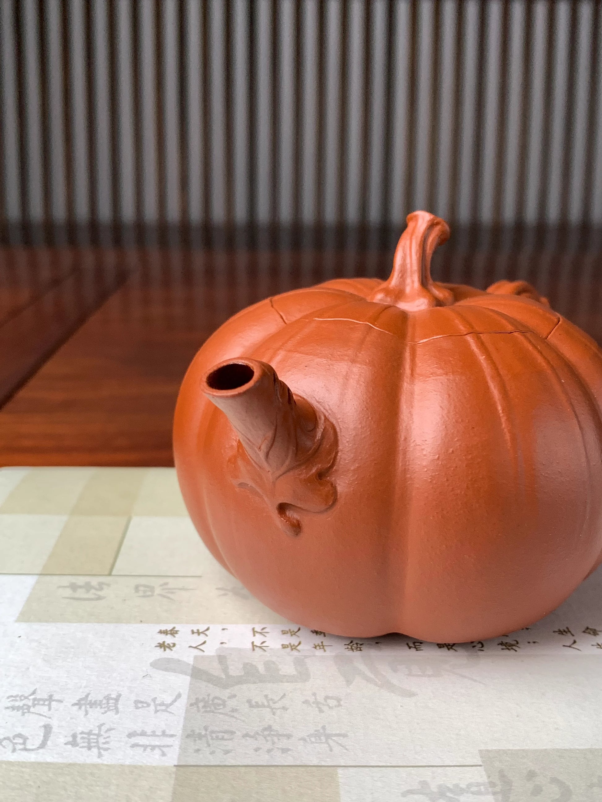 spout details of the collectible teapot named pumpkin on the table