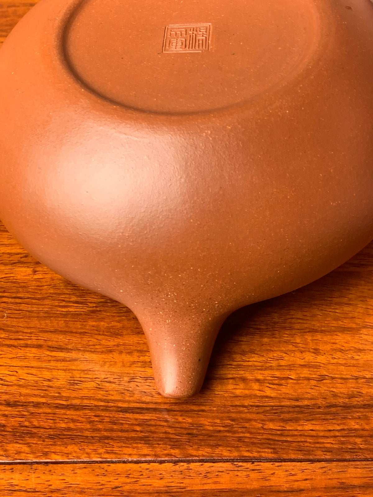 Turn the teapot upside down and look at the base of the spout