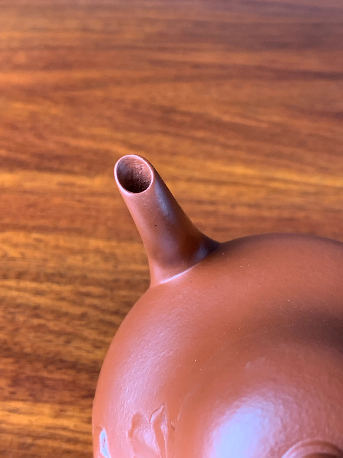 Looking down at the spout of the teapot