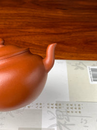 This teapot features a spout with gracefully flowing lines.