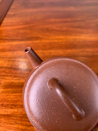 Look down at this teapot and observe its lid and spout