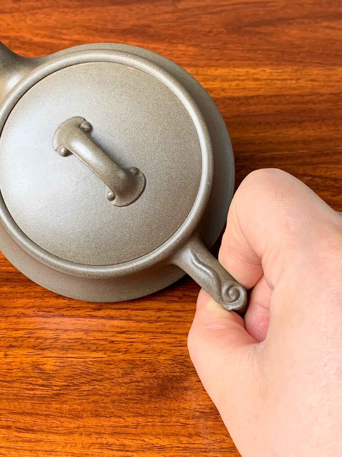 Viewed from above, the ruyi patterns on the lid knob and handle.