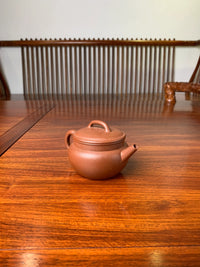 the teapot artwork named fu on the table left view