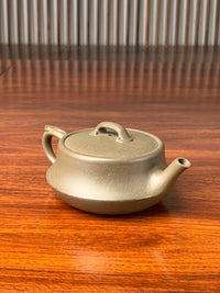 the right view of the teapot artwork named ru yi on the table
