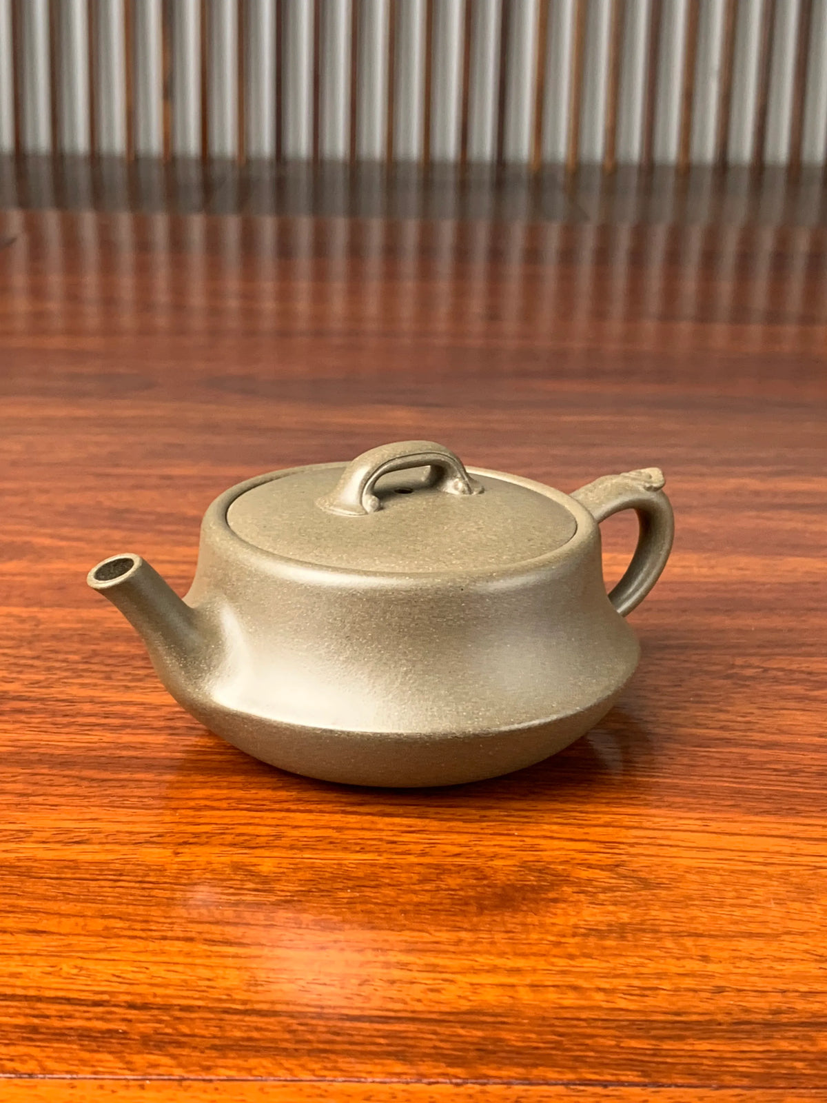 the left view of the teapot artwork named ru yi on the table