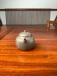 the front view of the teapot artwork named green parrot