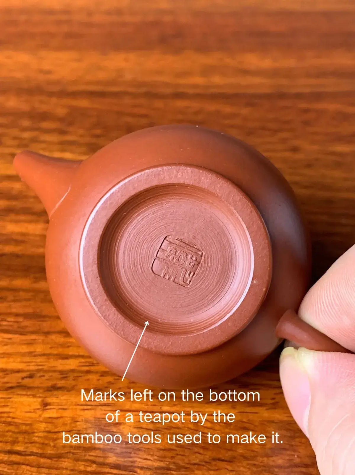 The bottom of the teapot shows traces left by bamboo tools during the handmade crafting process
