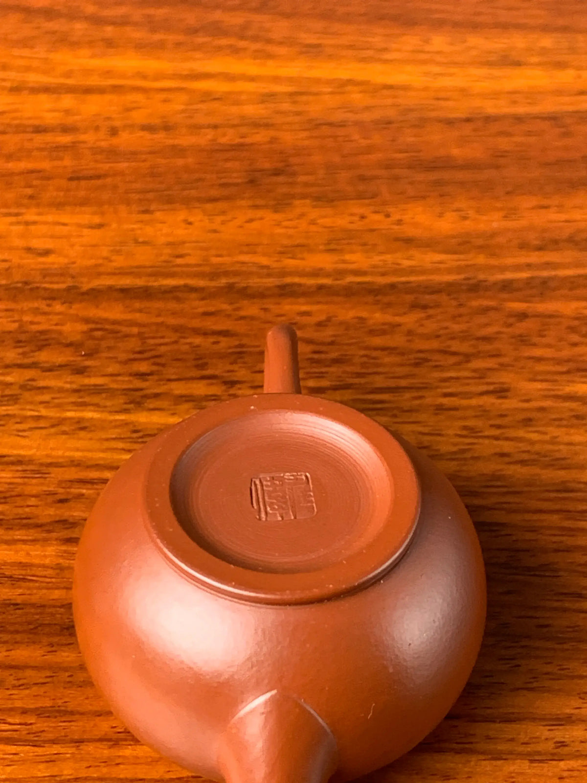 Looking down at the artist’s seal on the bottom of the teapot