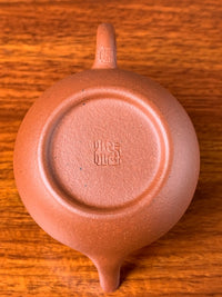 Looking down at the fine workmanship on the bottom of the small Yixing teapot li xing