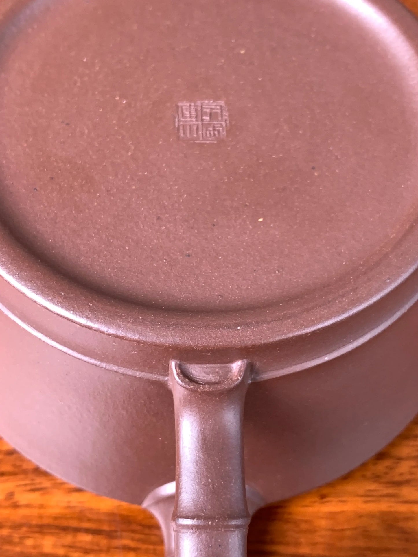 With the teapot turned upside down, the intricate details of the handle are revealed in close-up