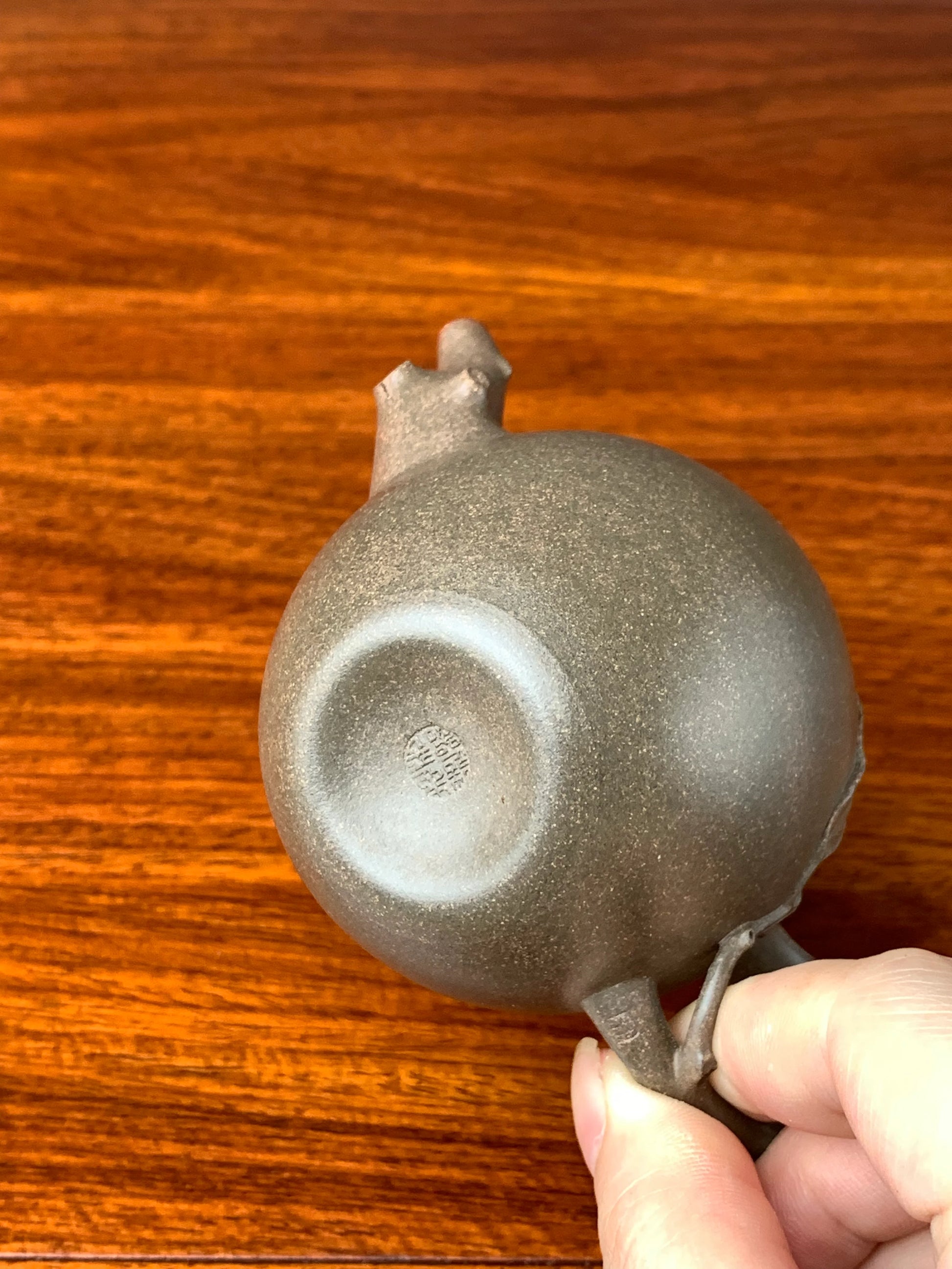 The bottom of the teapot has shrinkage lines on the base piece from the fully handmade process.