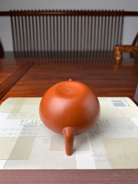 Upside down, the teapot bottom shows a bottom with full, rounded lines.