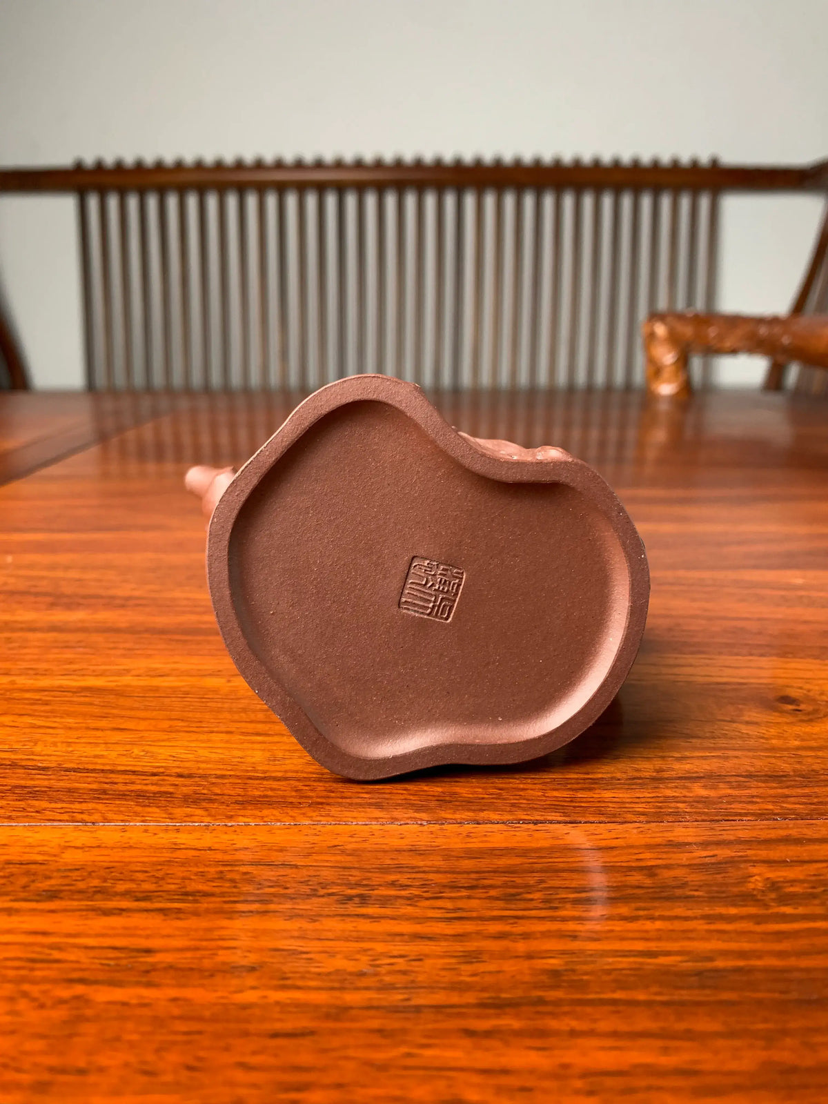 A close-up view of the seal of the artist Wu Hong Kang on the bottom of the teapot