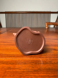 A close-up view of the seal of the artist Wu Hong Kang on the bottom of the teapot