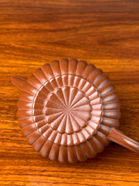 Take a close look at the graceful lines on the bottom of this Yixing teapot.