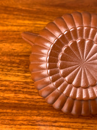 A close-up photo of the lines on the bottom of the yixing teapot